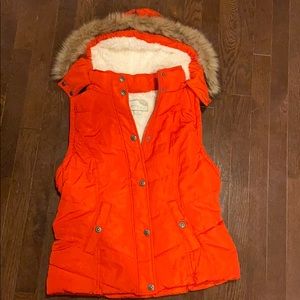 Red puffer vest with removable hood.